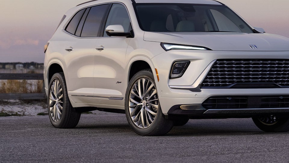 Close-up of wheels on Buick SUV driving through the city